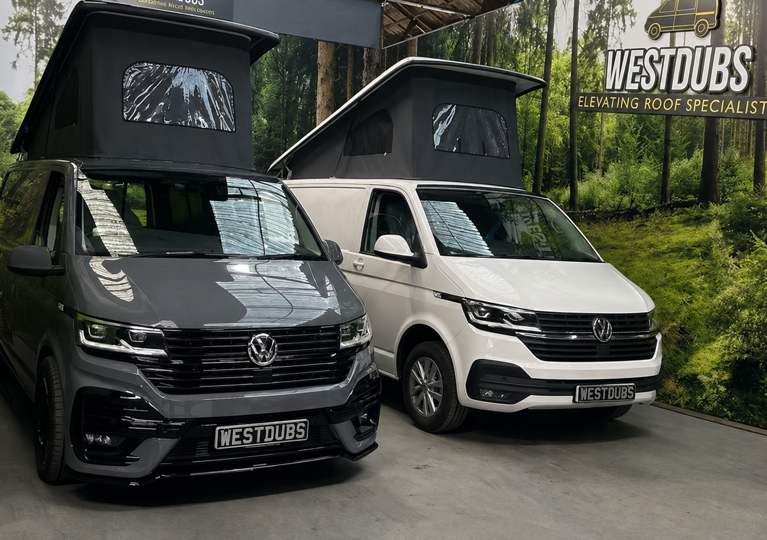 Grey and white VW Transporters fitted with Westdubs elevating roofs, both raised